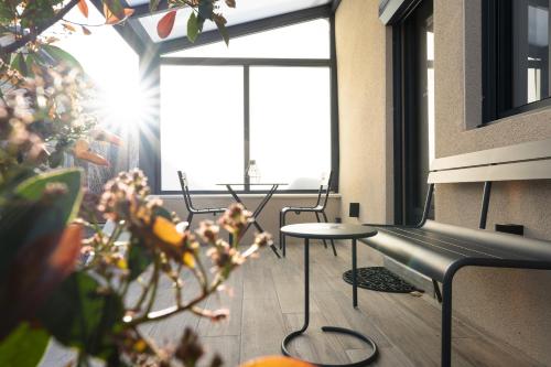 a waiting room with a bench and a window at La Suite SPA privatif du Moulin in Saint-Laurent-dʼAndenay