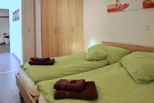 two beds in a room with towels on them at Leuchtturm 4 in Großenbrode