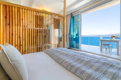 a bedroom with a bed and a large window at Sofia Ada in Fethiye