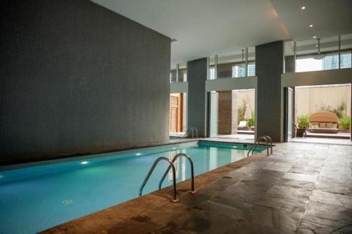 a swimming pool in the middle of a building at Nasma Luxury Stays - Limestone House in Dubai