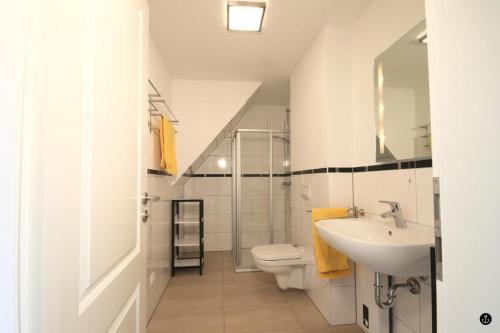 ein Bad mit einem Waschbecken und einem WC in der Unterkunft Blankwasser 8 in Grömitz