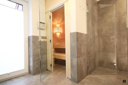 a bathroom with a shower with a glass door at Störtebeker 6 in Kellenhusen