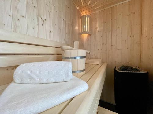 a sauna with a bench in a wooden room at Dahmer Strand 7 in Dahme