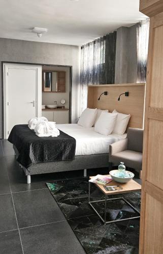 a hotel room with a bed and a couch at Villa Valkenburg in Valkenburg