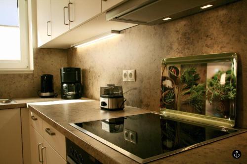 a kitchen with a counter top with a coffee maker at Refugium 6 in Kellenhusen