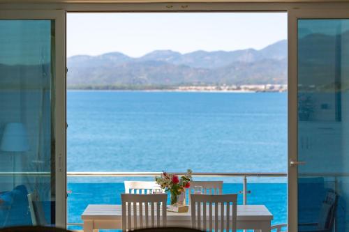 a table with a vase of flowers on a balcony at Sofia Ada in Fethiye