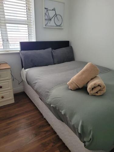 a bed with a towel on it in a bedroom at Stylish 4 Bedroom Dublin House in Dublin