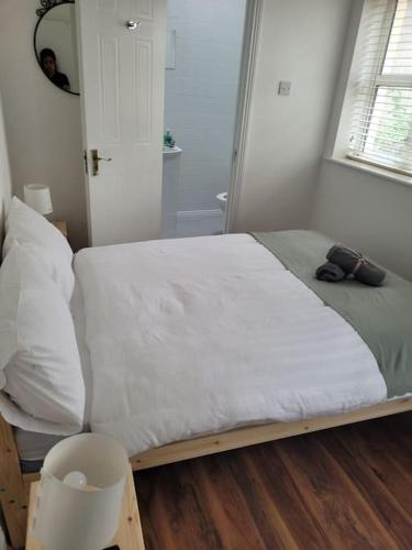 a bedroom with a large bed with white sheets at Stylish 4 Bedroom Dublin House in Dublin