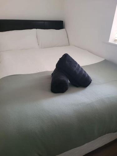 a stuffed animal is sitting on a bed at Stylish 4 Bedroom Dublin House in Dublin