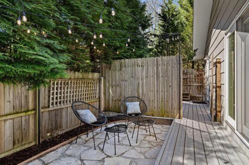 a patio with two chairs and a fence at Hidden Haven in Union Pier