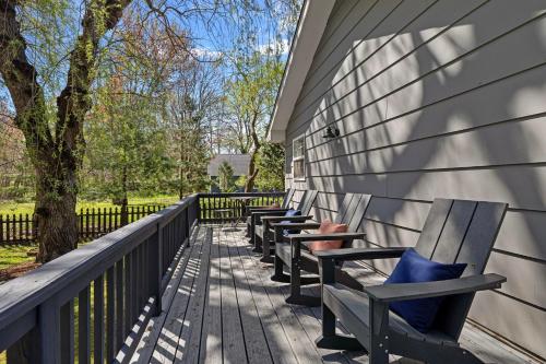 a row of benches sitting on a porch at Hidden Haven in Union Pier