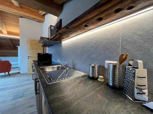 a kitchen with a sink and a counter top at Baita La Pesse - Ad un passo dalle stelle in Nus