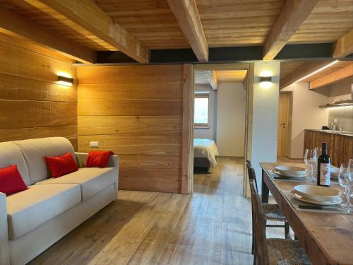 a living room with a white couch and a table at Baita La Pesse - Ad un passo dalle stelle in Nus