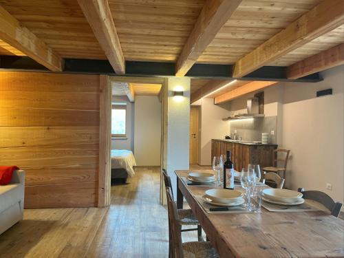 a dining room with a table and a room with a bed at Baita La Pesse - Ad un passo dalle stelle in Nus