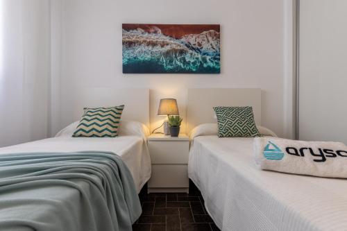 two beds sitting next to each other in a room at DMS 5 1ª Planta Arysal 1 in Cambrils