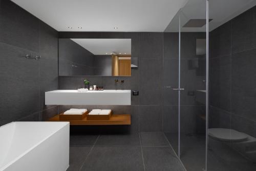 a bathroom with a white sink and a shower at Sofia Hotel Sea Of Galilee in Tiberias