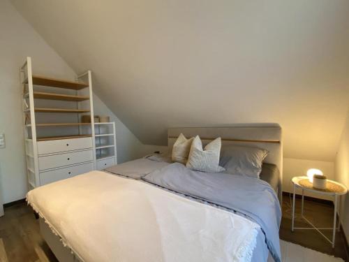 a bedroom with a bed with a ladder and a shelf at Meerglück CUX in Cuxhaven