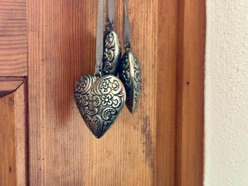 a pair of hearts hanging on a door at Michels Haus in Piotta