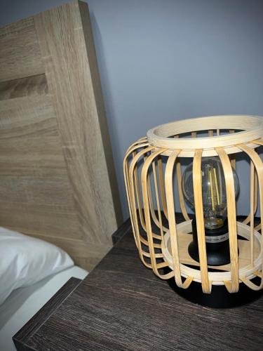 a wicker basket sitting on a table next to a bed at Joannas Airport Luxury Rooms in Artemida