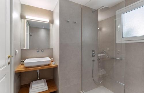 a bathroom with a shower and a sink at Bella Mare Hotel in Kassiopi