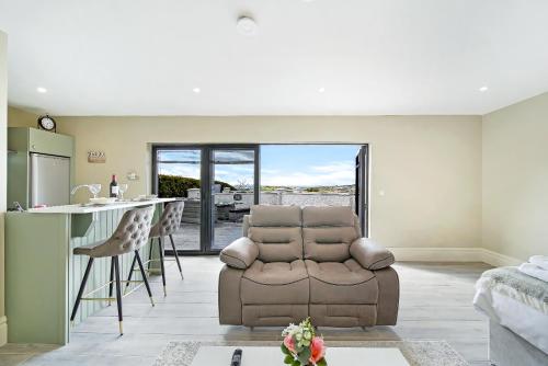 a living room with a couch and a kitchen at Seaview Lodge Studio 'Sleeping 2 guests' in Burnfoot