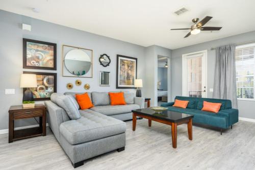 a living room with a couch and a table at Newly Renovated Premium Condo, Vista Cay - 2002 in Orlando
