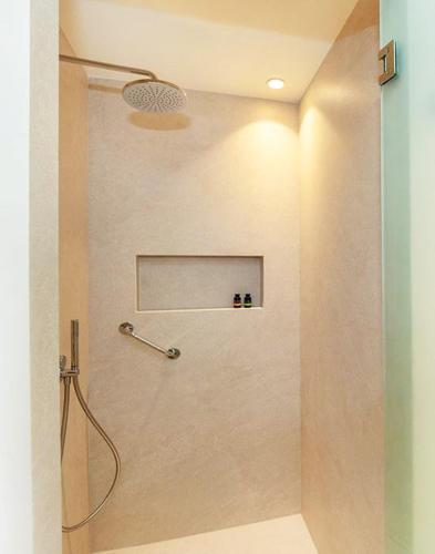 a shower stall in a bathroom with a shower head at Bella Mare Hotel in Kassiopi