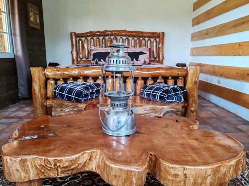 a wooden table with a coffee table with a vase on it at Finca Chuchiyá cabañas Tecpan in Tecpán Guatemala