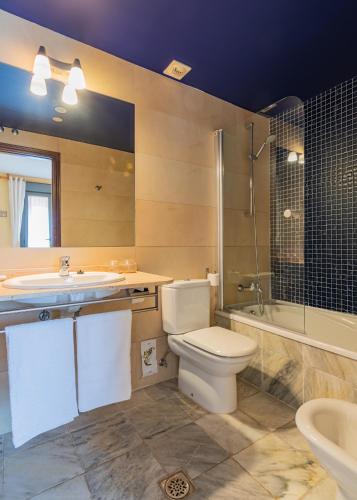 a bathroom with a toilet and a sink and a shower at Mar Del Sueve in Colunga