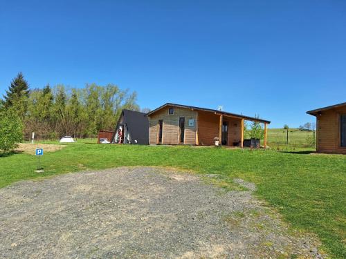 a large yard with a house and a building at Kameralne pole namiotowe, ZABIERZ SWÓJ NAMIOT, blisko Świeradów i zamek Czocha in Giebułtów
