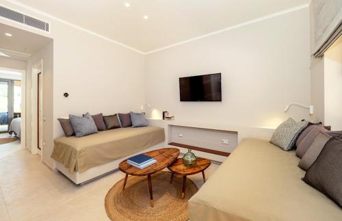 a living room with a couch and a table at Bella Mare Hotel in Kassiopi