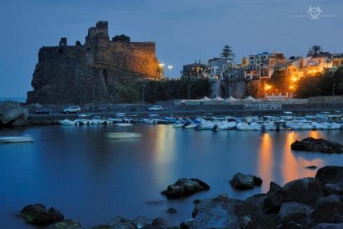 a large body of water with boats and a castle at Casa Paradiso sul Mare delle Aci in Aci Catena