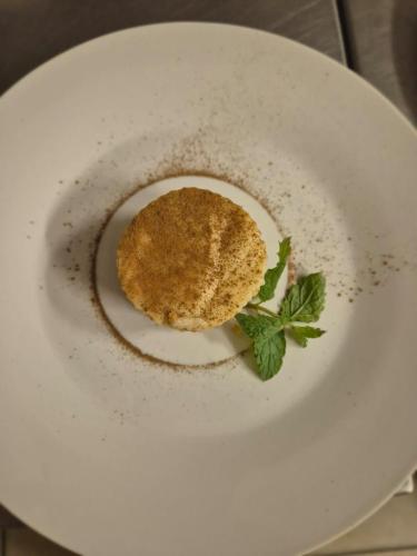a sandwich on a white plate with a green garnishment at Zambezi Dusk in Livingstone