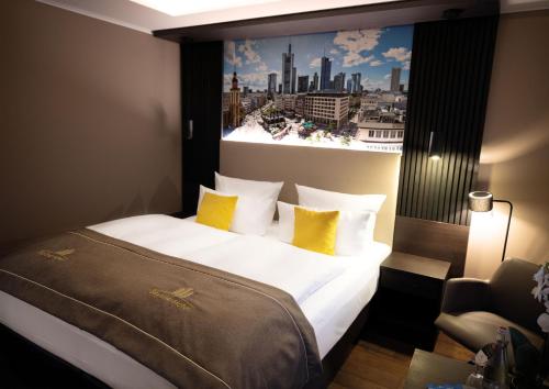 a bedroom with a large bed with yellow pillows at Skyline Hotel City Frankfurt in Frankfurt