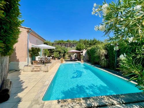 une piscine dans l'arrière-cour d'une maison dans l'établissement Charmante Maison Piscine, à Pont-Saint-Esprit