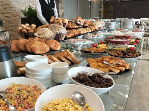 a buffet with many different types of food on a table at Grand Plaza Hotel & Resort in Qaryat ash Shamālī
