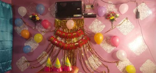 a wall with a bunch of balloons and a dress at Shri Ganga kashi homestay in Varanasi