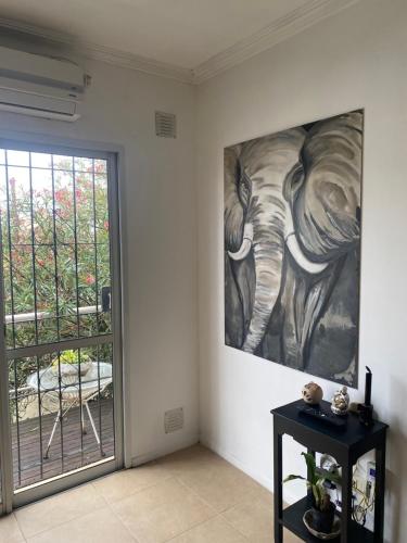 a painting of an elephant on a wall next to a door at Mar in Junín