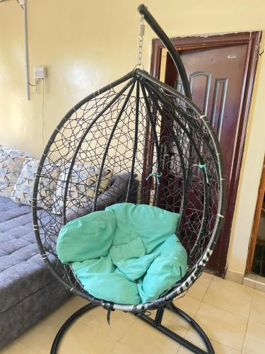 a basket swing with a pillow in a room at Paradise Apartments in Kilifi