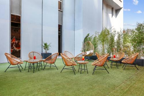 a group of chairs and tables on a patio at Novotel Paris Est in Bagnolet