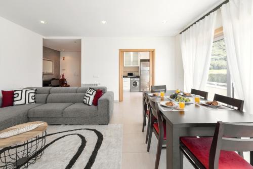 a living room with a couch and a table at Nazaré Beach House in Nazaré