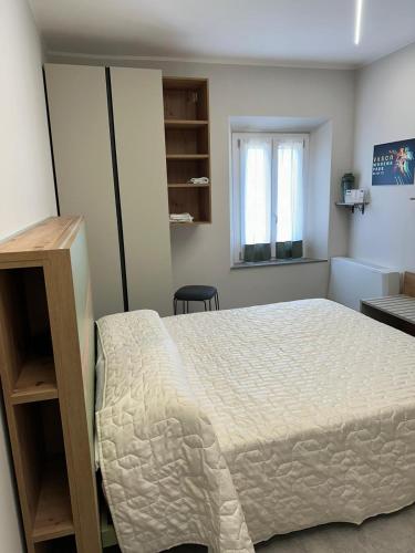 a bedroom with a large bed and a window at B&B Borgo Saludecio Rooms in Saludecio