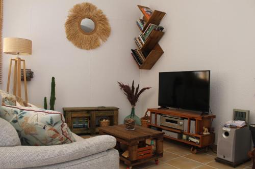 a living room with a couch and a flat screen tv at Habitación en piso compartido Room in shared flat in Torremolinos