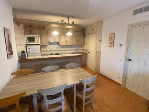 a kitchen with a large wooden table and chairs at Casa La Gavina in Riumar