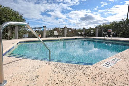 a large swimming pool with a metal rail around it at Wingate by Wyndham Savannah Pooler in Savannah