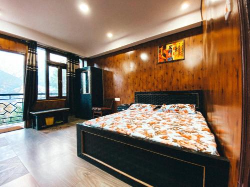 a bedroom with a bed with a wooden wall at HOTEL NIRVANA in Kalpa