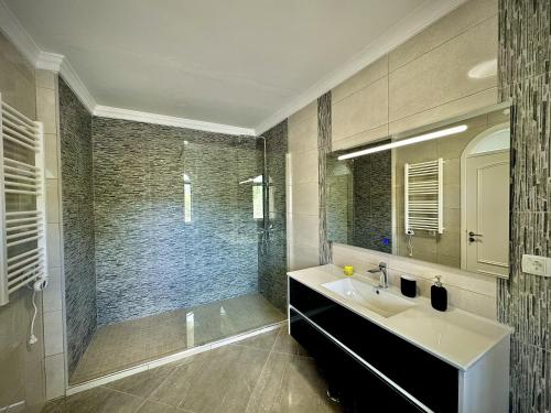 a bathroom with a sink and a shower at Quarteira Premium Villa With Pool by Homing in Quarteira