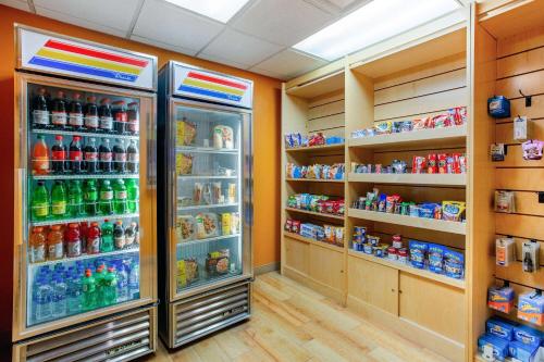 a room with a refrigerator filled with lots of drinks at La Quinta by Wyndham Raleigh/Durham Southpoint in Durham
