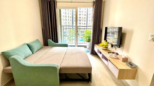 a room with a bed and a tv and a window at Fuji homestay Hạ Long in Ha Long