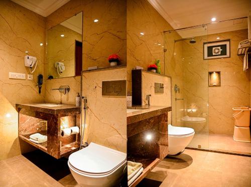 a bathroom with a toilet and a sink and a shower at Cresent Villa in Varanasi